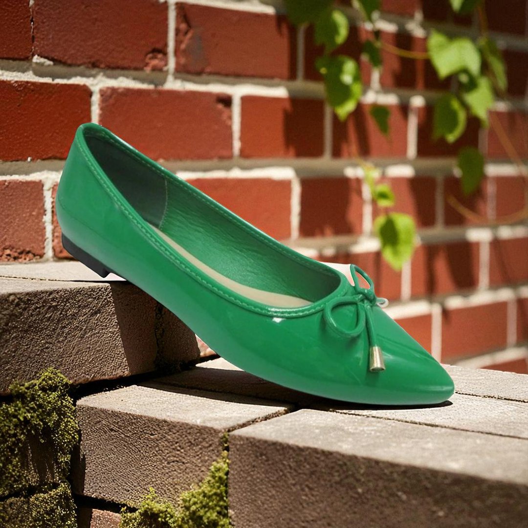 green sneakers sit in a paved road that disappears over the horizon