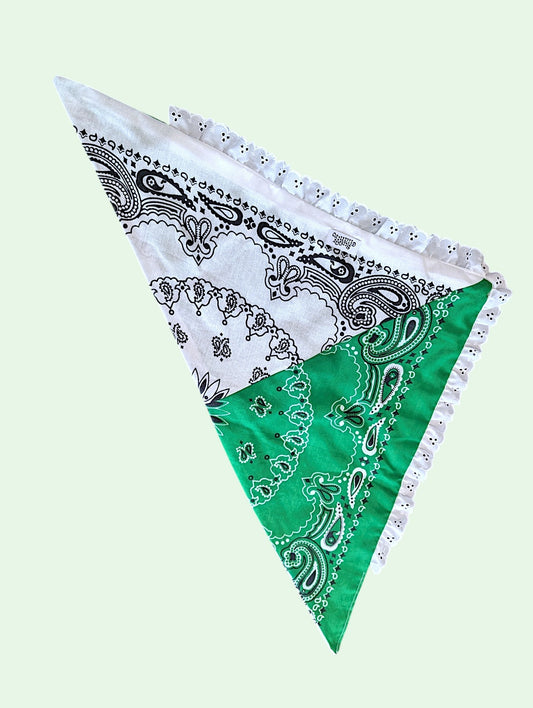 A triangular bandana-style pet scarf with a white and green paisley pattern and white lace trim, shown on a pale green background.