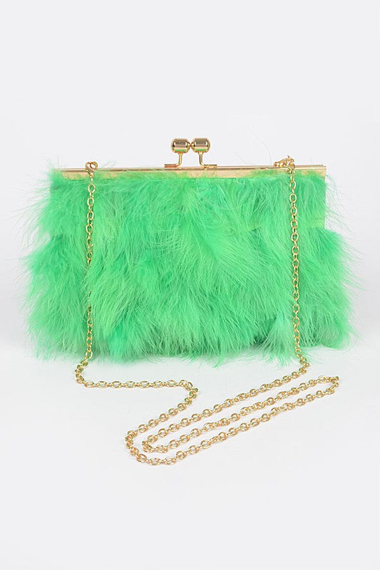 the clutch is shown with its feather size out and gold shoulder chain curled beside it