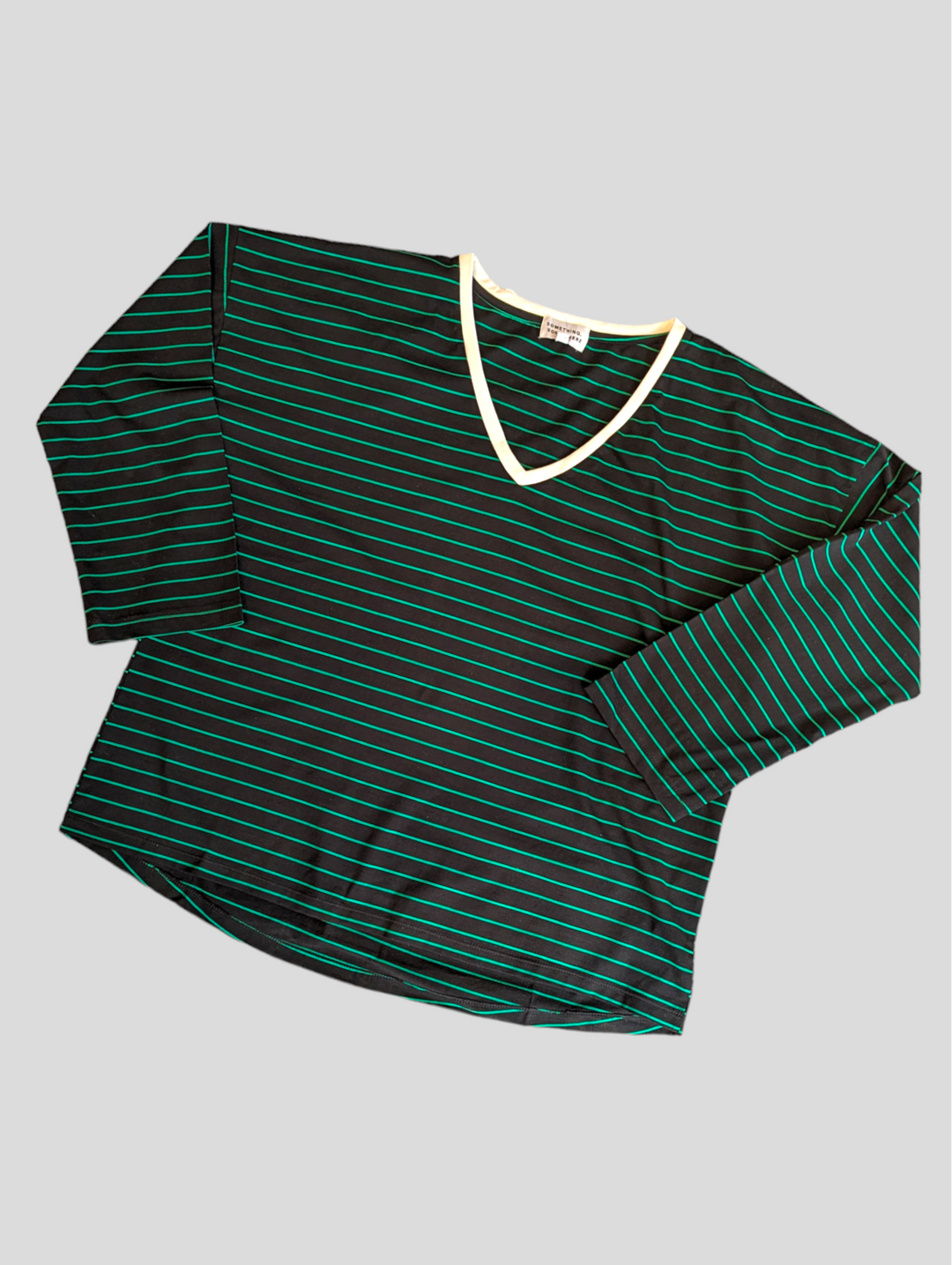 A black and green stripe long sleeve tee in a flat lay pattern