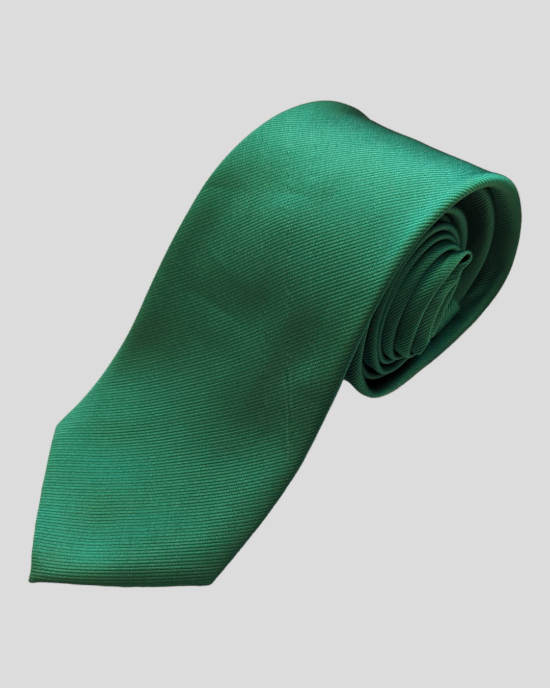 a solidgreen necktie lies coiled and ready to pounce. not really, just put it on.