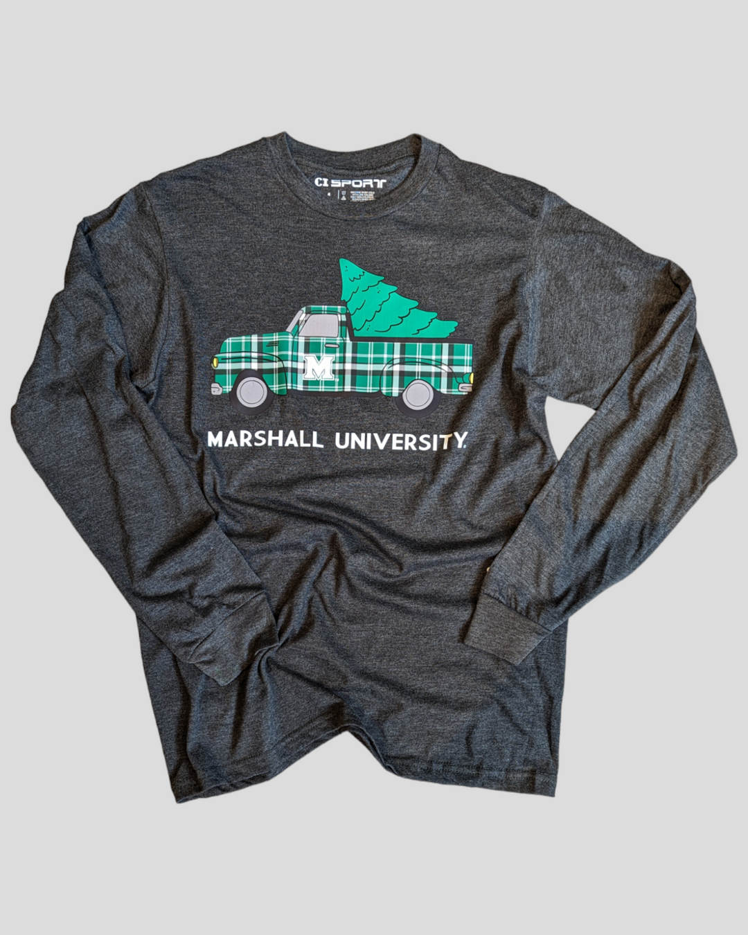 a flat lay shot of the holiday truck tee showing the design on the front of a plaid truck hauling a green christmas tree with Marshall University in block lettering underneath.