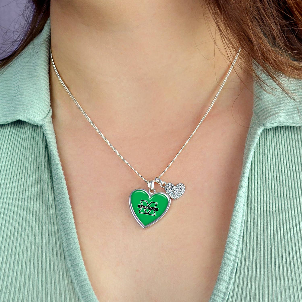 the  necklace is shown up close on a model wearing a light green top