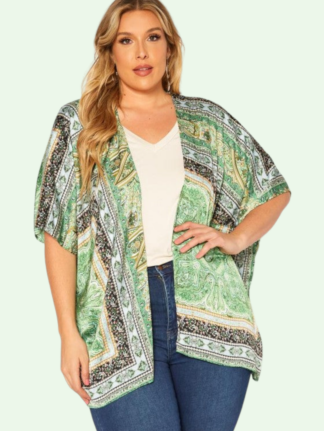 a plus sized model stands with her hand on her hip showing us the front view of the boho kimono cardigan