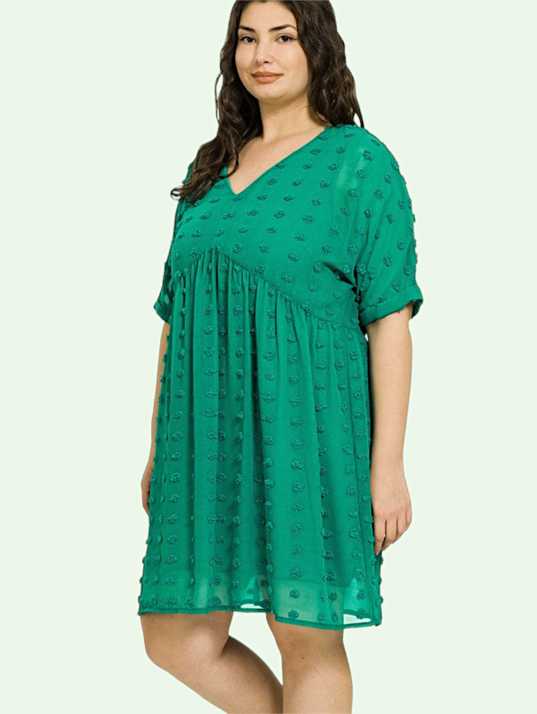 a dark haired model in the green clip dot dress
