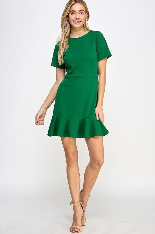 a blonde  model poses in a full length picture of the fluted hem dress