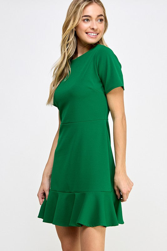 a blonde model shows up the side view of the fluted hem dress