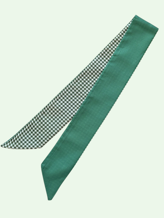 Green scarf with checkered pattern on a light green background