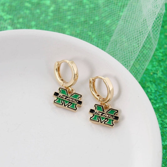 Gold hoop earrings with green and black logo on a white surface with green background