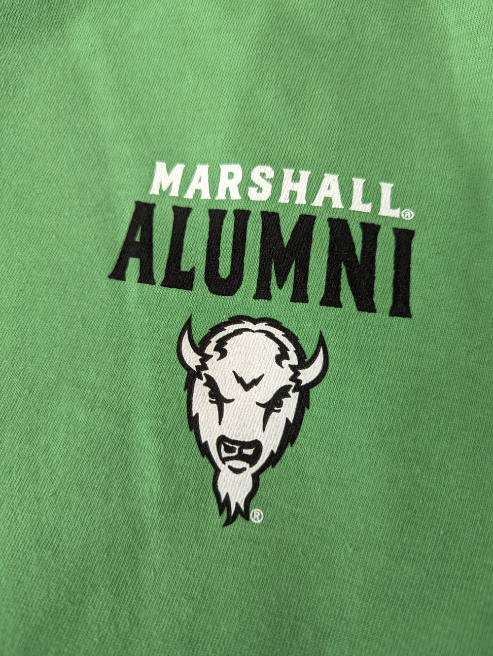 detail shot of the  men's alumni tee front with the black and white marco logo