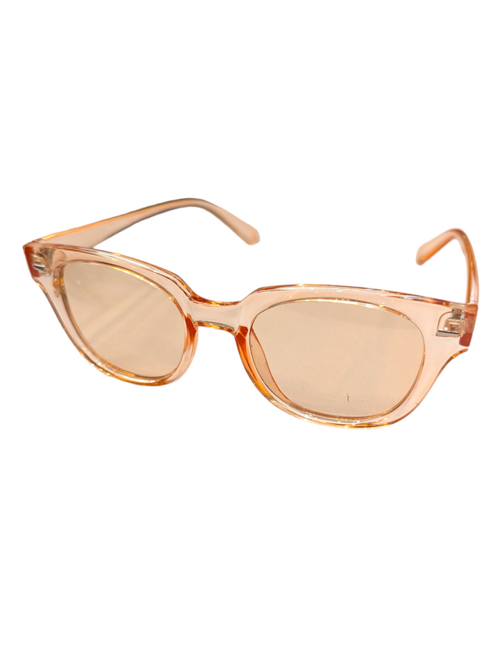 the perfect vacation sunglasses with peach frames and lenses