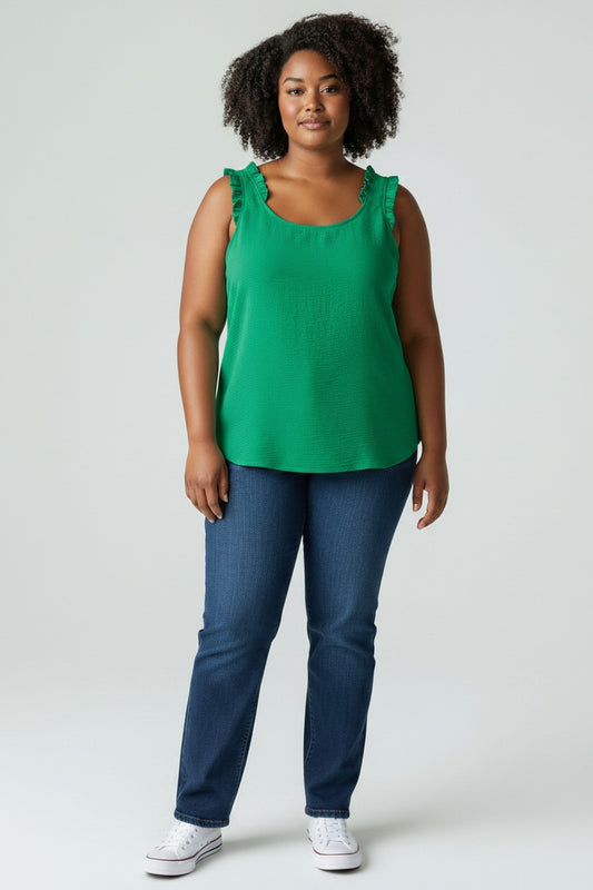 Woman wearing a green sleeveless top and blue jeans on a white background