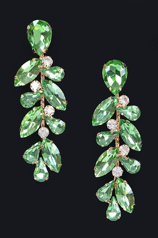 green stones fall from a central drop earring along a gold trailing vine, interspersed with clear rhinestone accents. 