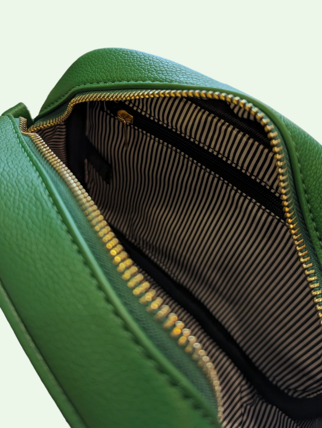 an alternate interior shot of the tassel crossbody bag showing us the zipper pocket and the stripe lining