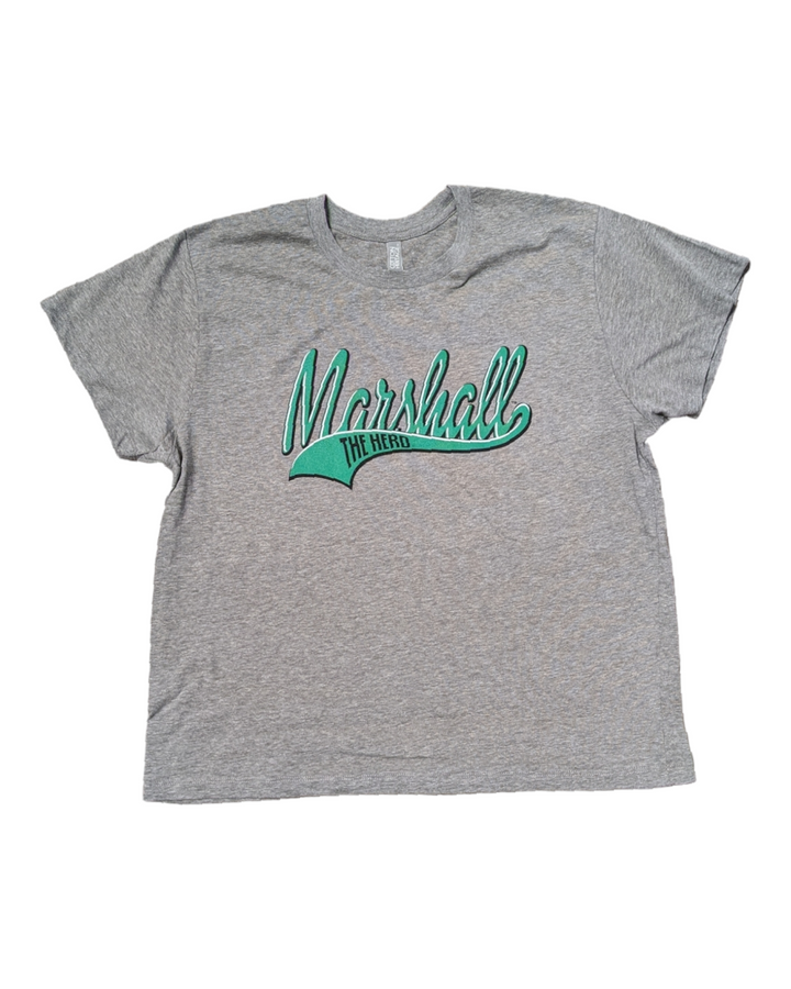 a flat lay of the Tina Tee that shows an artistic interpretation of a marshall logo with a tailsweep detail