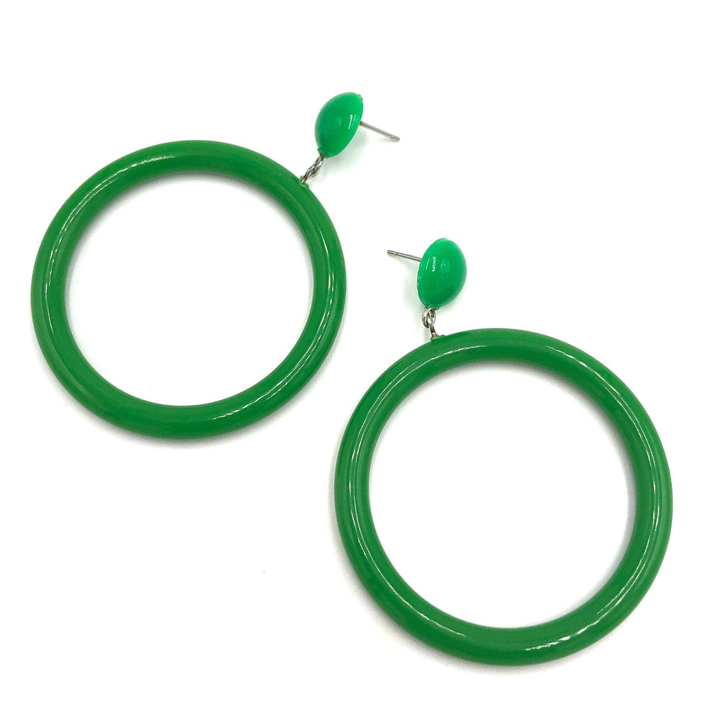 Kelly green button stud hoop earrings laying on white background