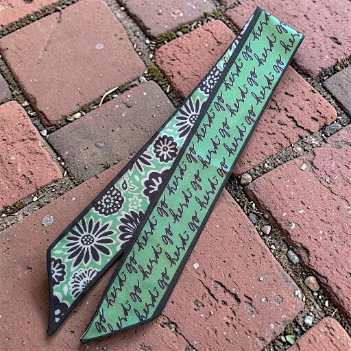 skinny scarf on a brick sidewalk