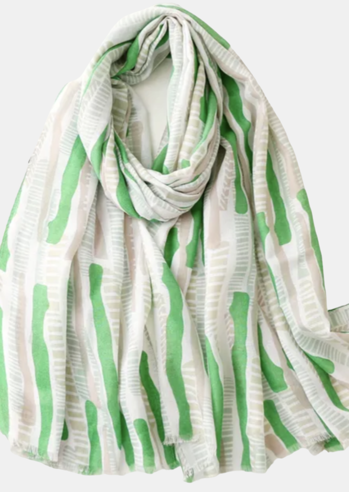 a large scarf with a light color background and lime colored bars and tan patterened sections