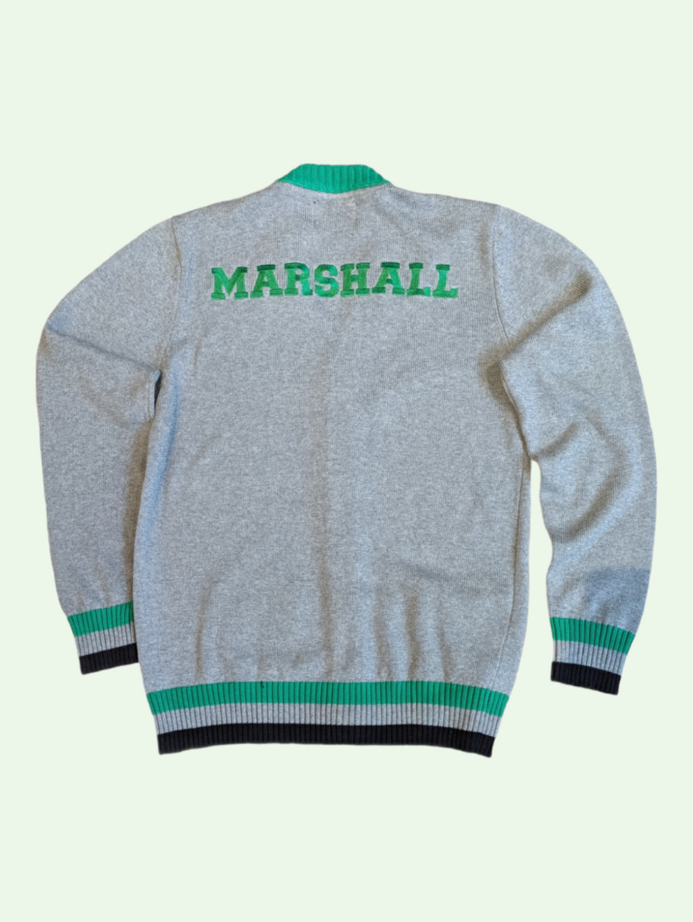 the back of the cardigan showing an embroidred "marshall" across the shoulders