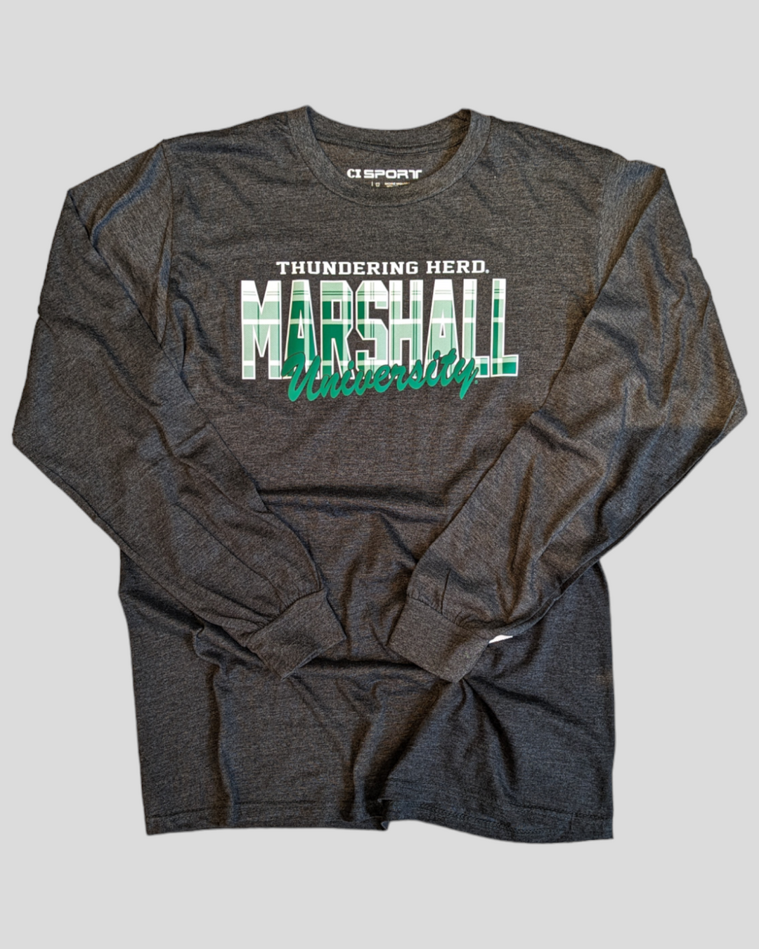 the shirt is shown in a flat lay and shows the word Marshall in plaid with University in solid green  with Thundering Herd in solid white block letters over top of the design