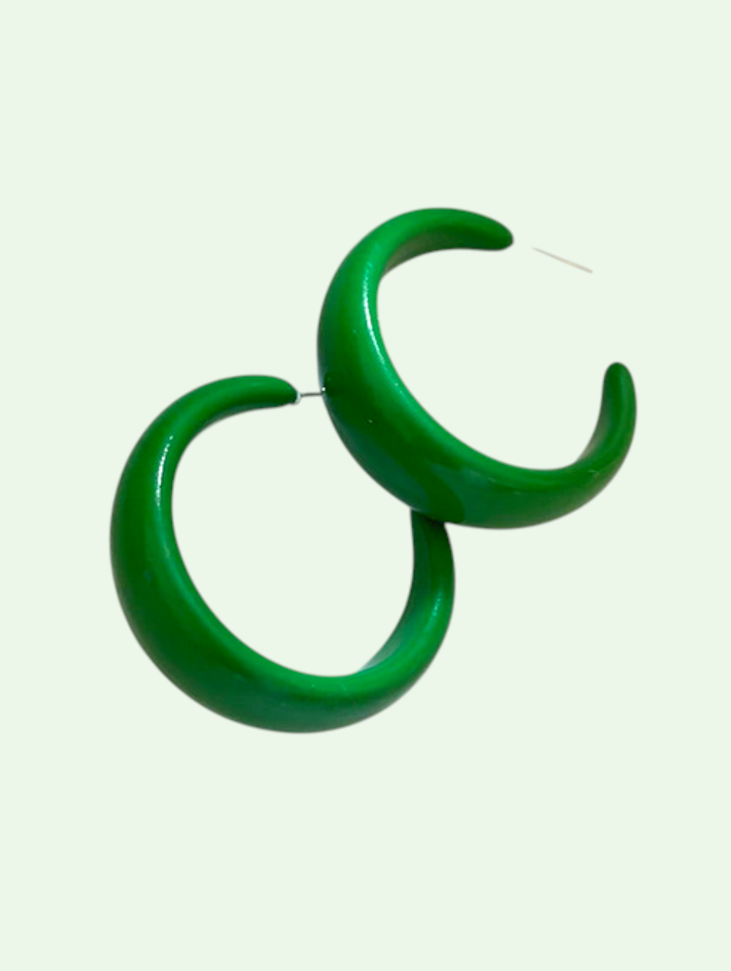 Green hoop earrings on a white background