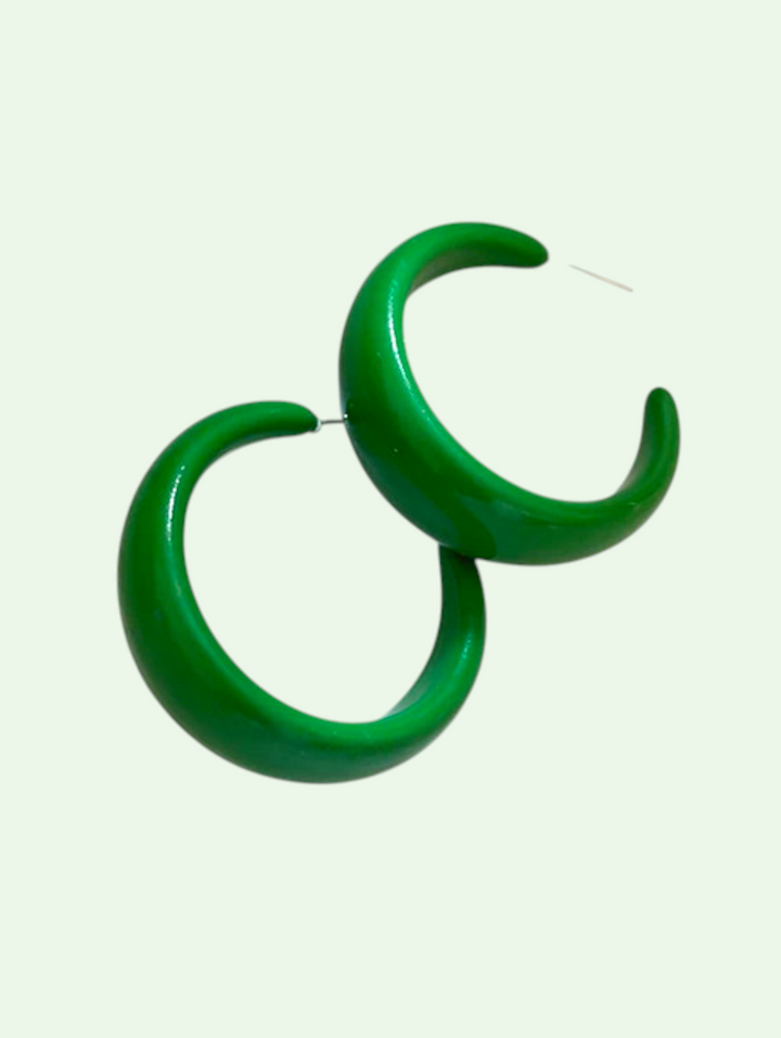 Green hoop earrings on a white background