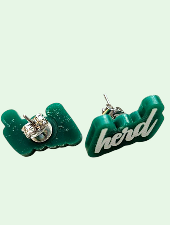 Green earrings with 'herd' text on a light green background