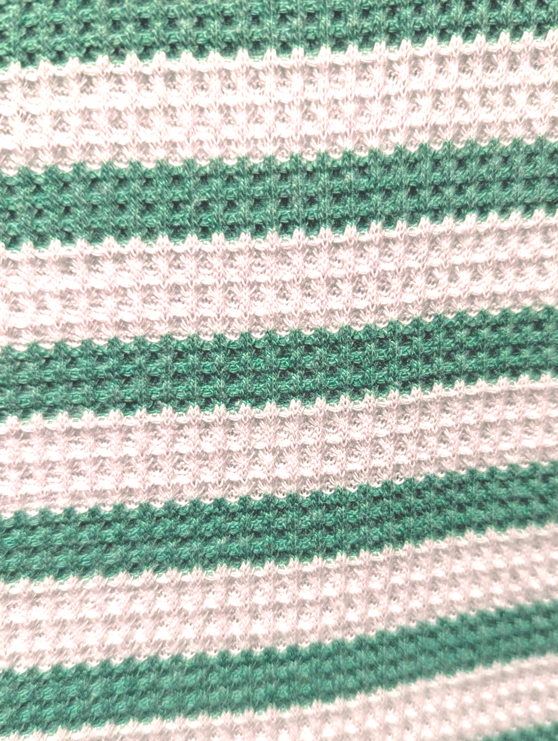 Close-up of green and white striped fabric texture