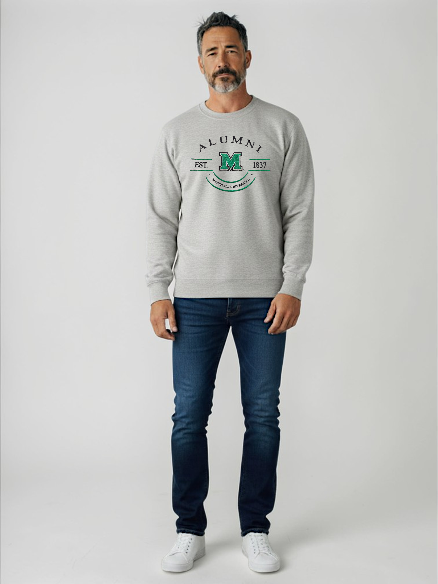 Man wearing a gray sweatshirt with 'Alumni' text and blue jeans on a white background
