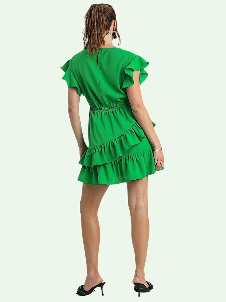 back view of the Green dress with ruffled details on a white background
