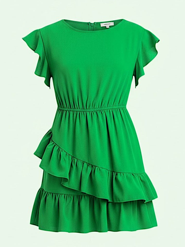 Green dress with ruffled layers on a light green background