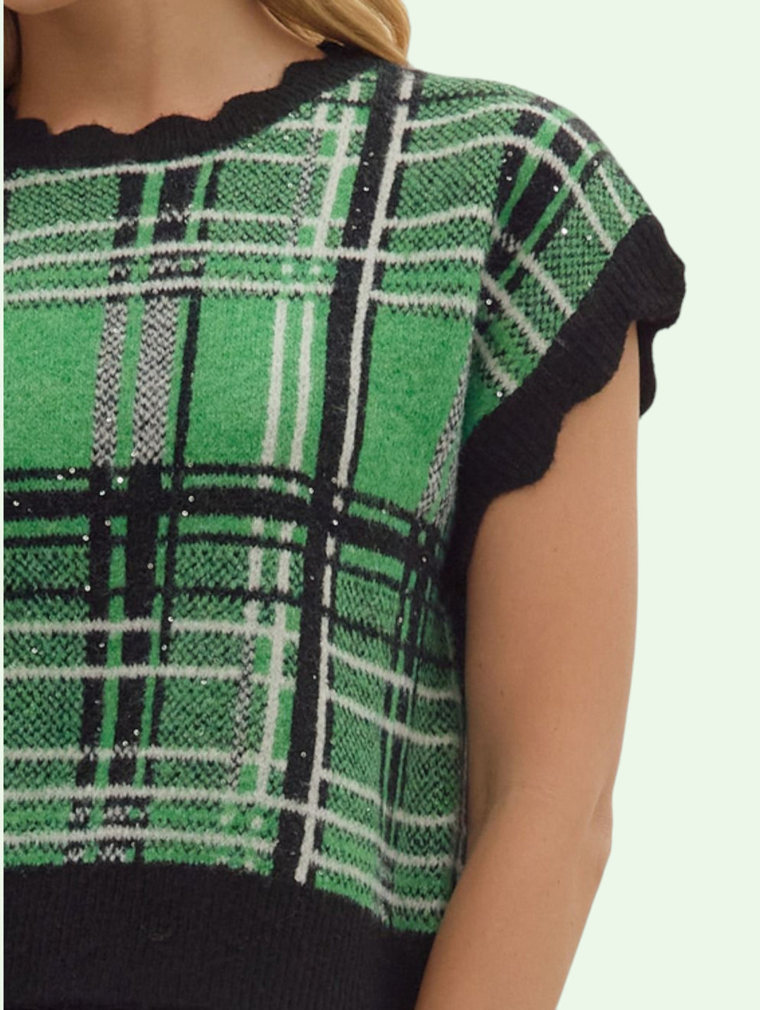 close up of the sleeve of the Green and black plaid dress with a plain background