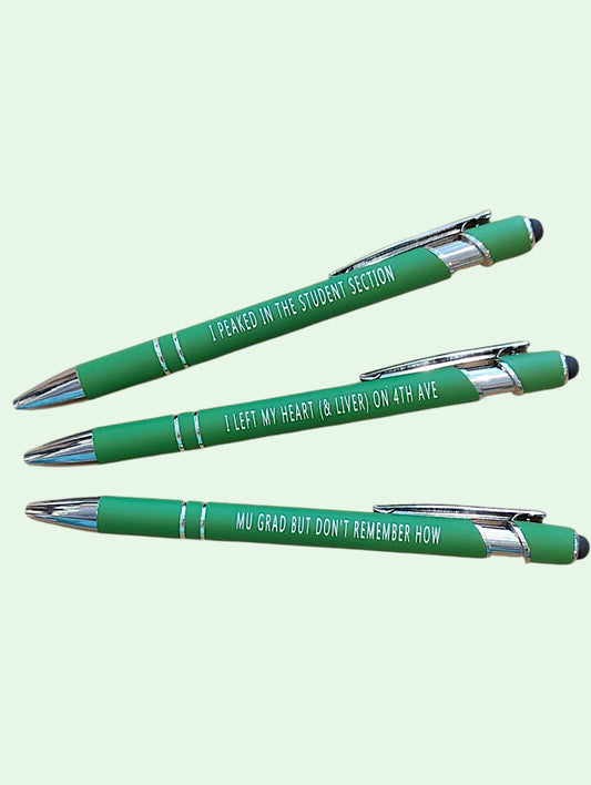 Three green retractable ballpoint pens with silver accents and white text, arranged diagonally on a pale mint green background. The pens read: 'I PEAKED IN THE STUDENT SECTION', 'I LEFT MY HEART ( & LIVER) ON 4TH AVE', and 'MY GRAD BUT DON'T REMEMBER HOW'.