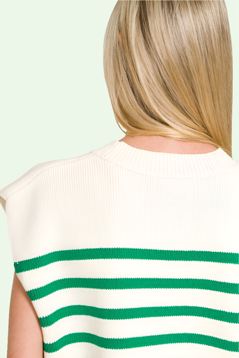 the blonde  model shows us the  back of the sweater vest