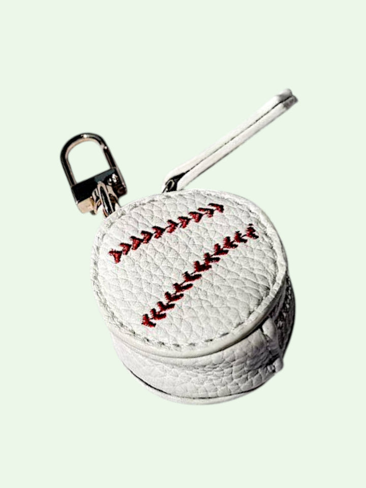 Baseball-shaped keychain with a lock on a light green background