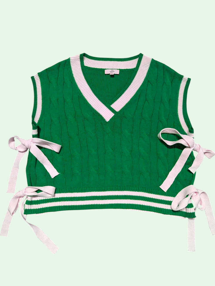 Green knitted vest with side ribbons on a light green background