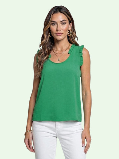 Woman wearing a green sleeveless top with ruffled shoulders on a light green background