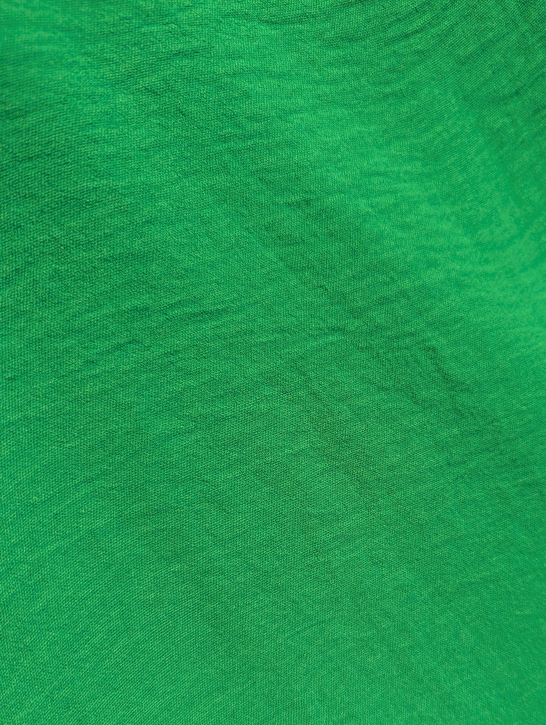 Close-up of green fabric with a visible texture