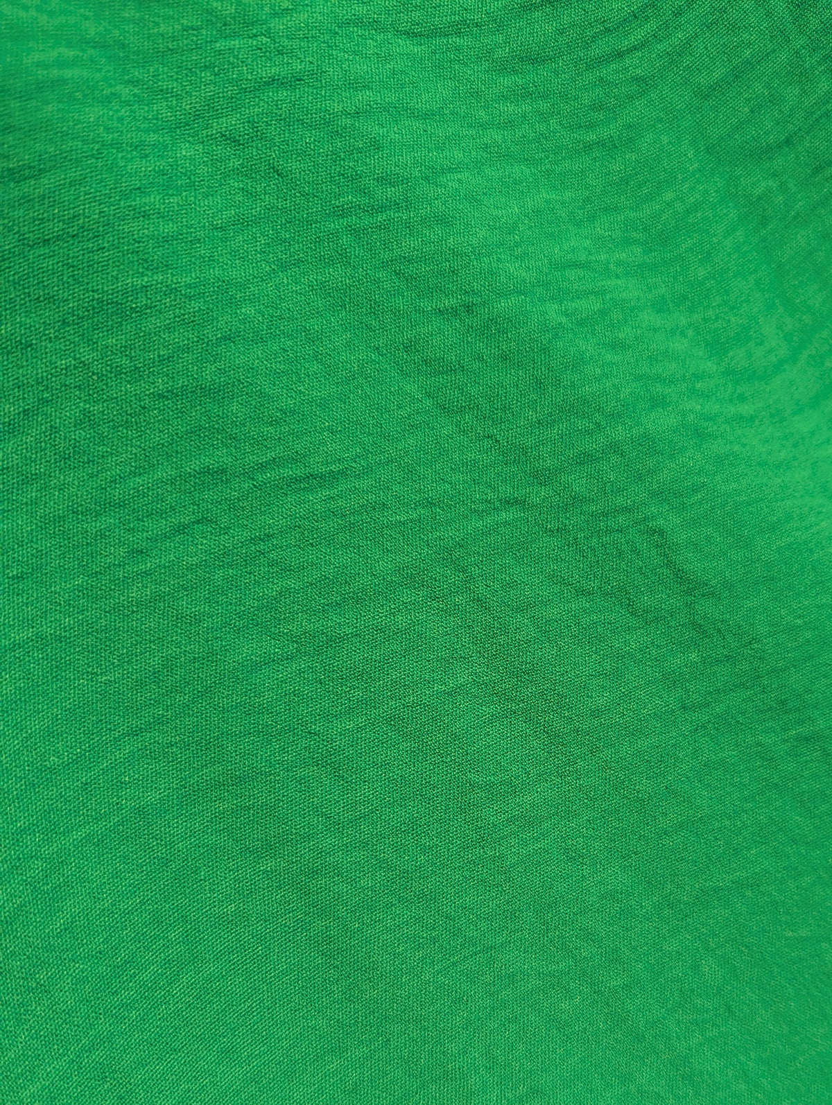 Close-up of green fabric with a visible texture