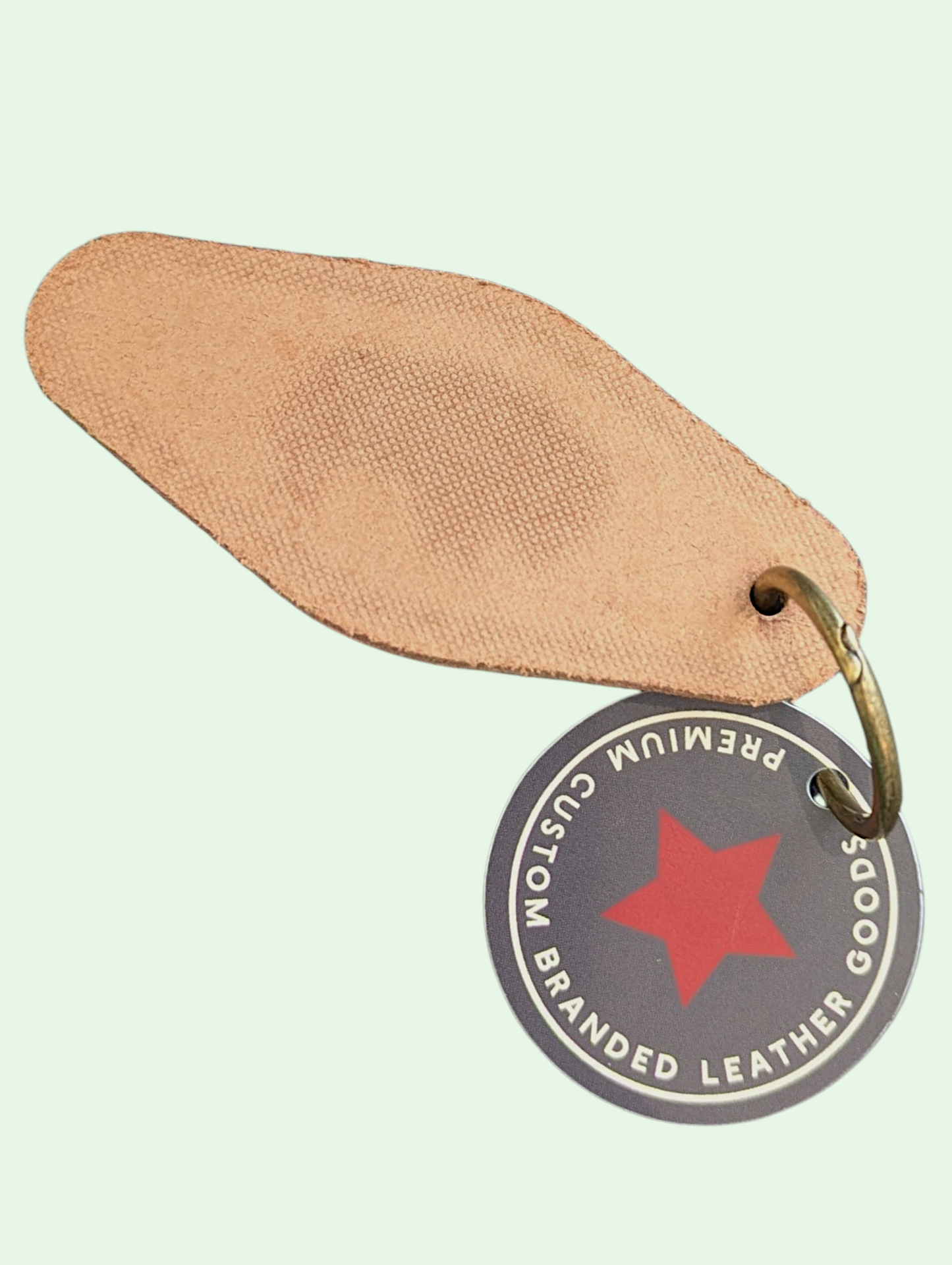 Brown leather tag with a red star and text on a light green background