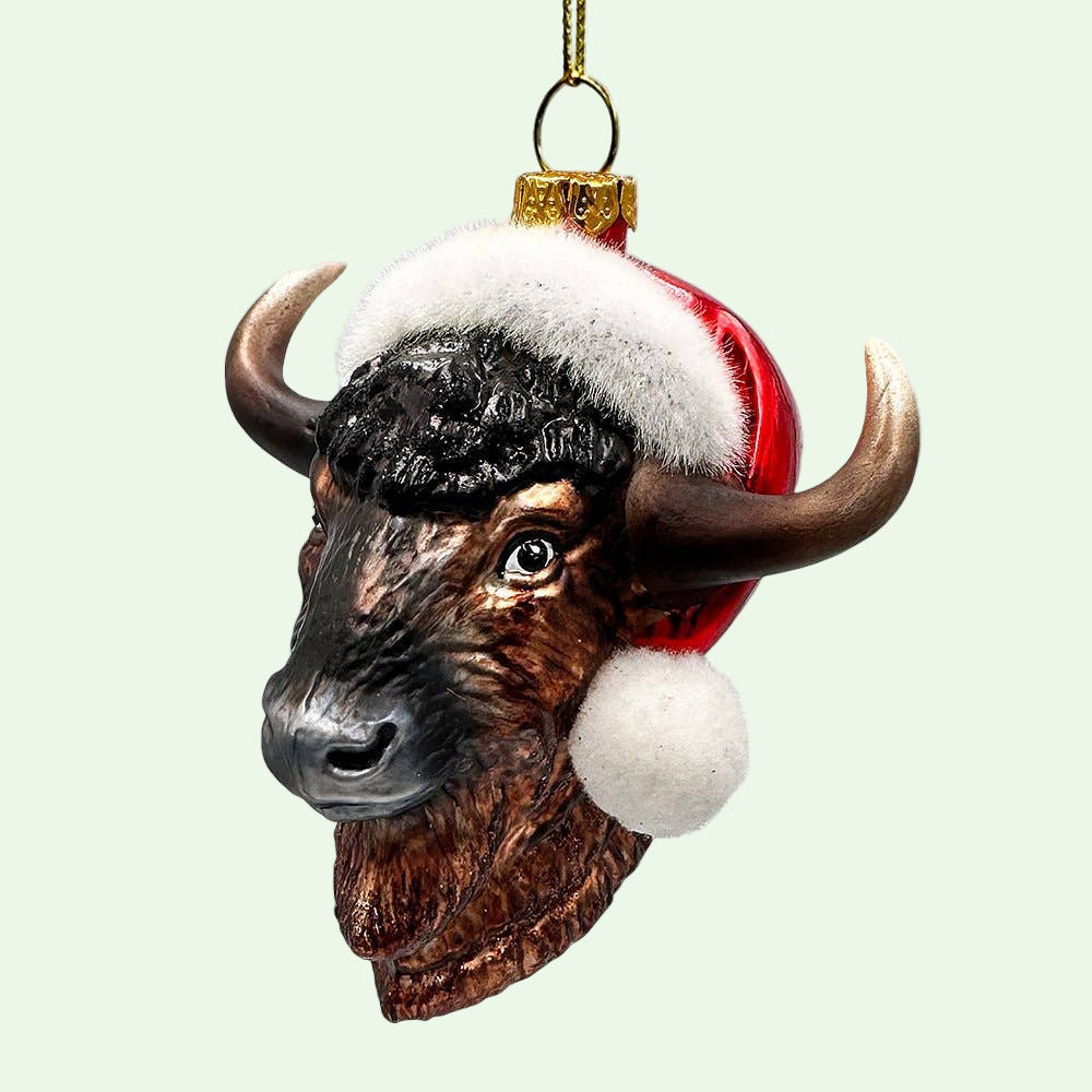 Decorative bull ornament with a Santa hat on a white background