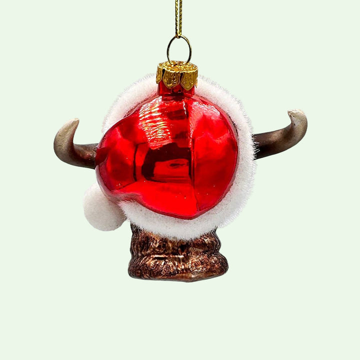 Christmas ornament with red ball, white fur, and gold accents on a white background