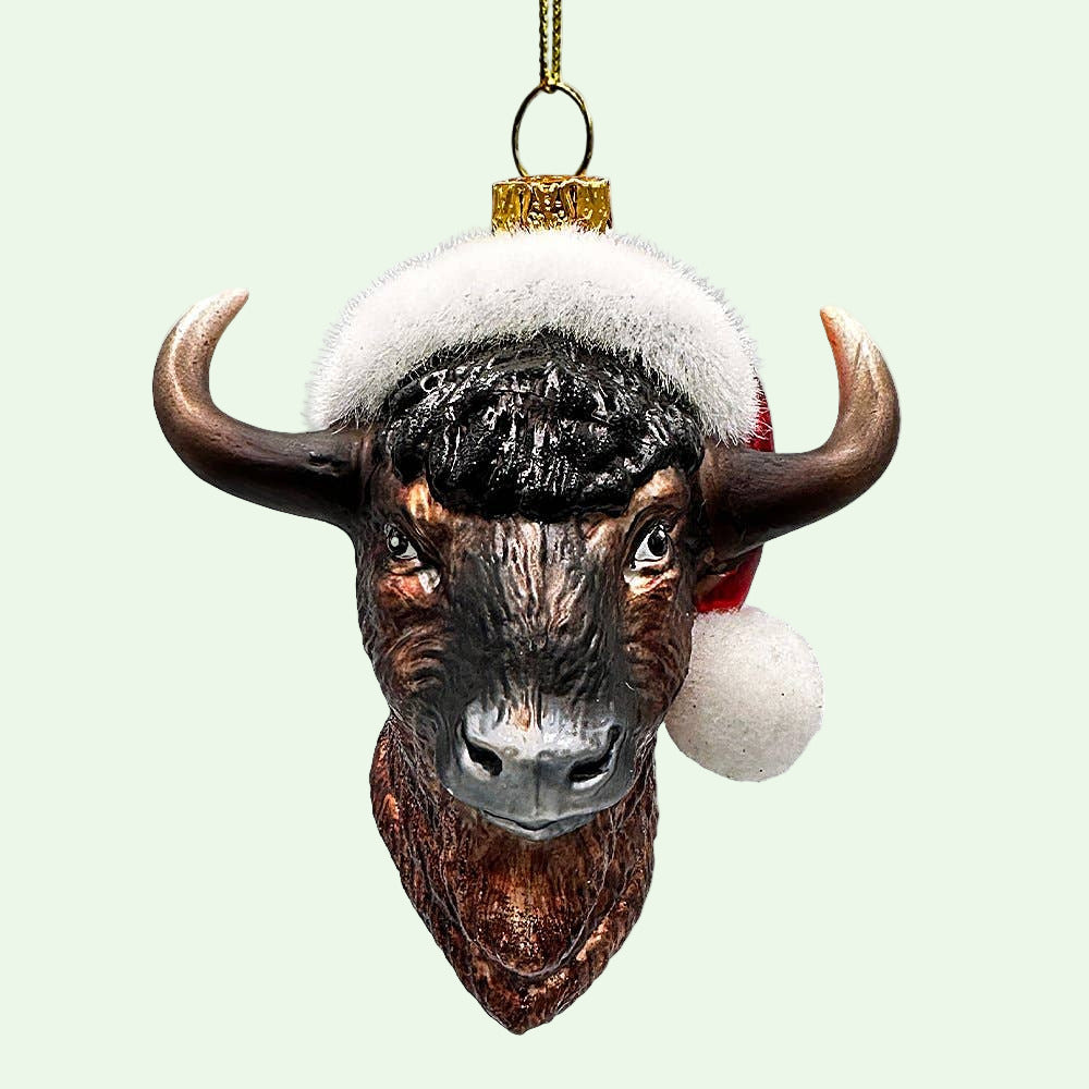 Bison head Christmas ornament with a Santa hat on a white background