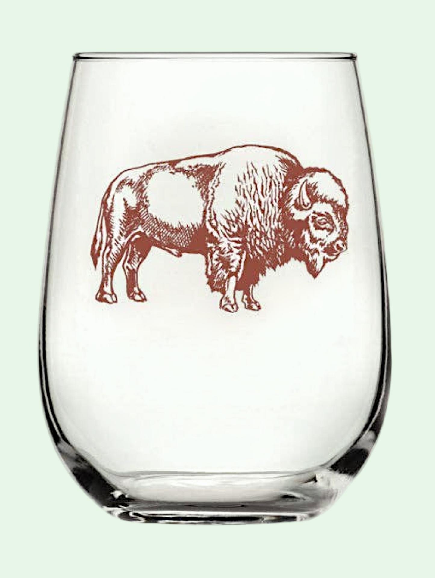 Clear glass wine glass with a brown bison design on a light green background