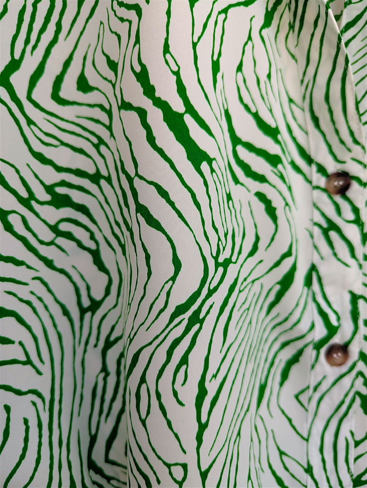 Close-up of a shirt with green and white zebra pattern