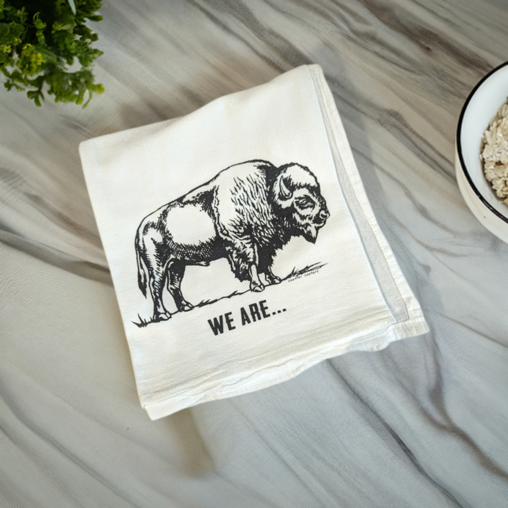 the buffalo towel is displayed on a marble countertop