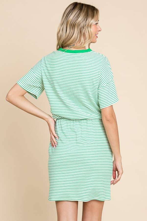 a blonde model, hand on hip, shows us the back of the stripe mini dress