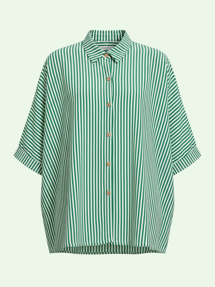 Green and white striped shirt on a light green background