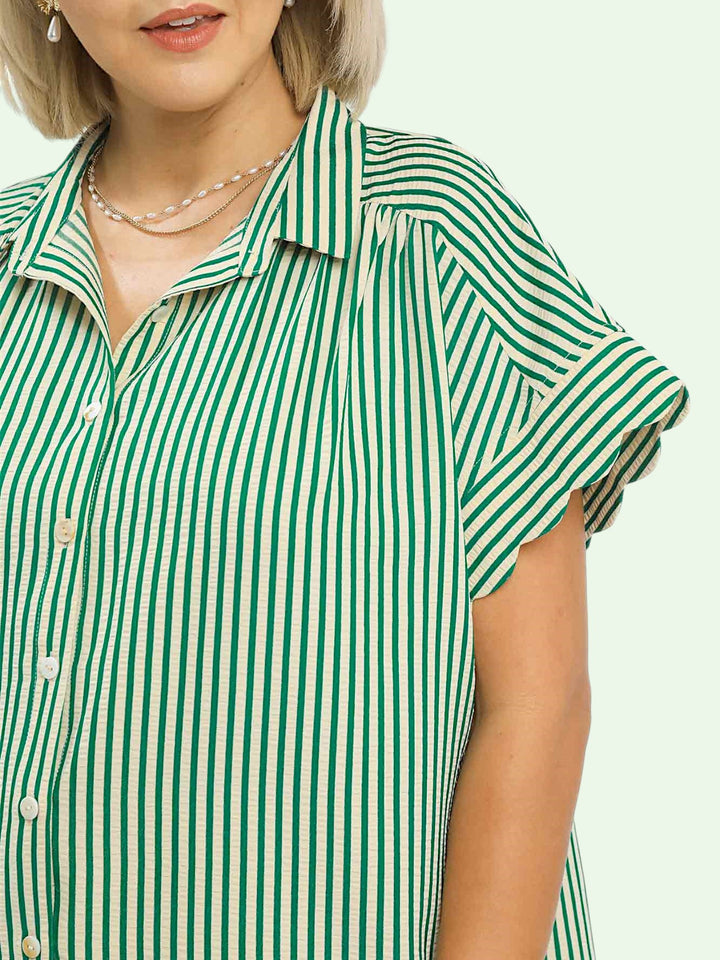 Green and white striped shirt worn by a person on a plain background