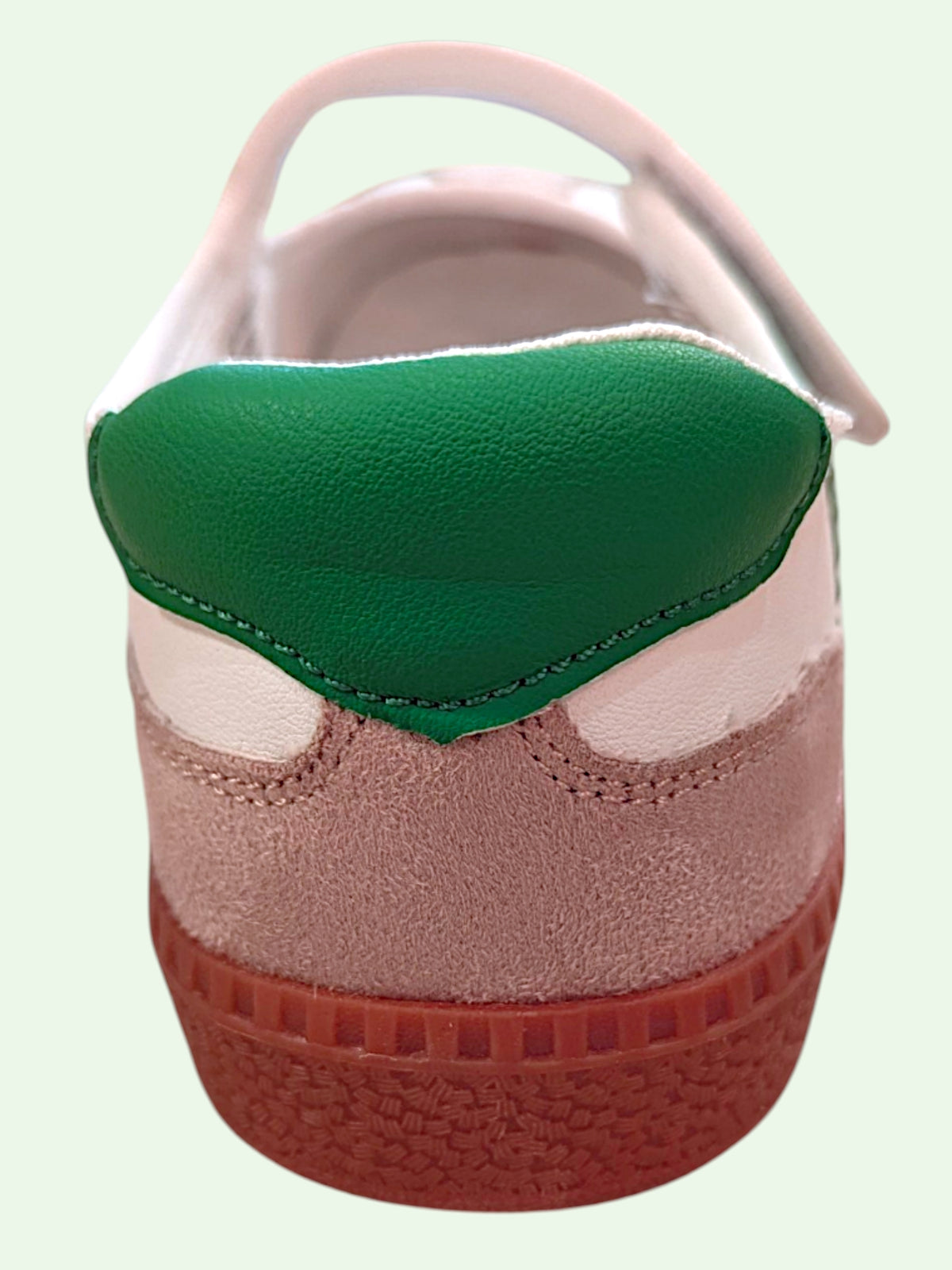 women's sneaker with green top and on a light background
